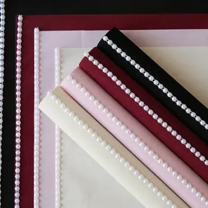 Audrey Hepburn style floral wrapping paper with elegant pearl trimming
