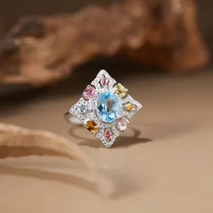 Macro detail of s925 sterling silver ring with light blue topaz and colorful gemstones