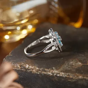 Detailed side view of an S925 silver ring with blue gemstones and hollow band design.