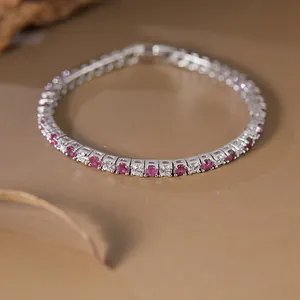 Macro view of a S925 silver tennis bracelet with alternating pink and white gemstones