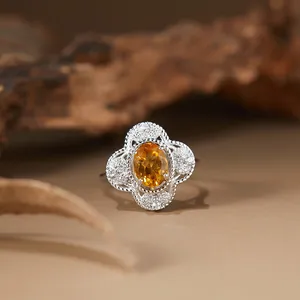 Macro detail of a natural citrine gemstone ring featuring an elegant filigree silver setting