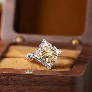 Macro view of vintage S925 silver ring featuring a natural yellow citrine flower motif