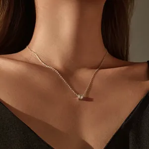Elegant S925 sterling silver necklace with a sparkling white topaz pendant detail view.