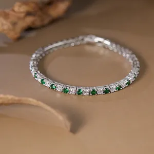 Close-up of S925 silver tennis bracelet with alternating green and white gemstones
