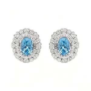 Detailed view of oval blue topaz earrings set in S925 sterling silver with halo stones.