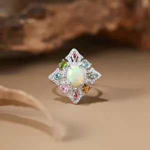 Macro view of vintage S925 silver ring with natural opal and colorful gemstones