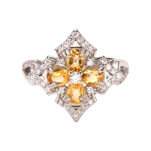 Close-up of vintage S925 silver ring with four oval-cut yellow citrine gemstones