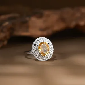 Eleganter S925 Silberring mit ovalem gelbem Citrin und funkelndem Halo-Blumendesign.