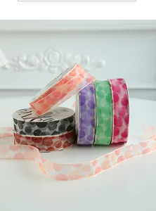 Detailed view of floral pattern on semi-transparent Freud organza ribbon for gift wrapping