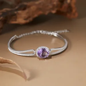 Close-up of S925 silver bracelet with round amethyst and micro-pave crystals.