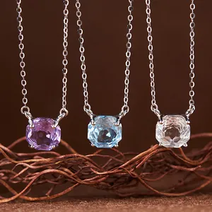Detail view of three S925 silver necklaces with amethyst, topaz, and clear quartz.