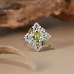 Macro detail of a vintage S925 silver ring featuring peridot and colorful gems
