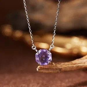 Macro shot of a faceted purple amethyst gemstone pendant on a S925 sterling silver chain