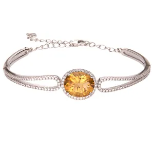 Detailed macro view of a S925 sterling silver bracelet featuring a faceted yellow topaz gem