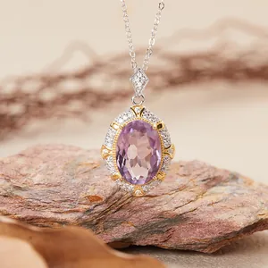 Close-up of vintage oval amethyst pendant necklace with halo of zircon on stone