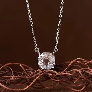 Detailed macro view of a 925 silver necklace with a faceted white crystal gemstone.