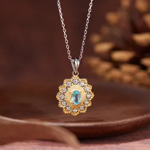 Detailed macro shot of a sun flower pendant necklace featuring a natural blue topaz