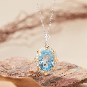 Macro detail of oval blue topaz pendant with sparkling halo on natural rock
