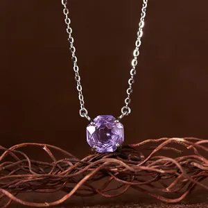 Close-up macro detail of natural octagonal purple amethyst pendant on sterling silver chain