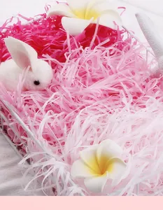 Detailed view of pink shredded raffia paper used for gift box decoration and box filler