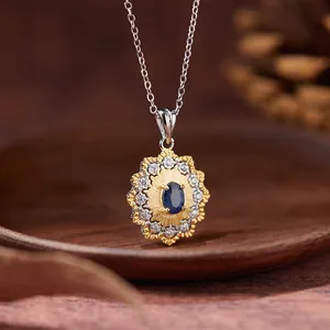 Close-up detail of vintage sunburst pendant with oval blue sapphire stone
