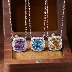 Detailed macro of three S925 silver necklaces with colorful gemstones in halo settings