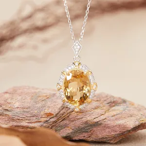 Detailed close-up of elegant oval citrine pendant necklace with sparkling stone accents