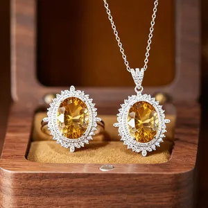Close-up of large oval citrine pendant and ring set in premium wooden jewelry box.