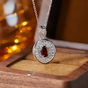 Macro detail of a vintage S925 silver necklace with an oval red garnet gemstone