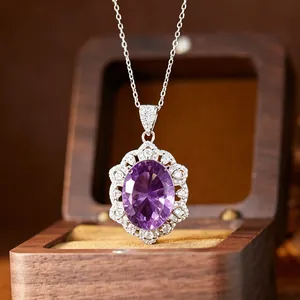 Gros plan d'un élégant collier pendentif améthyste violette ovale avec accents.