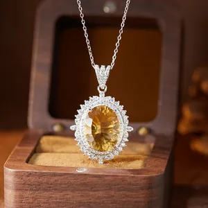 Detailed view of an oval citrine pendant set in S925 sterling silver halo design