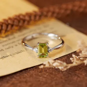 Close-up of elegant S925 silver ring with a rectangular green gemstone detail