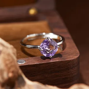 Macro view of a sterling silver ring featuring a hexagonal faceted purple amethyst gemstone