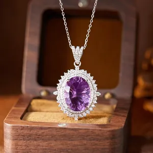 Detailed view of a large oval purple amethyst pendant set in sterling silver with halo stones.
