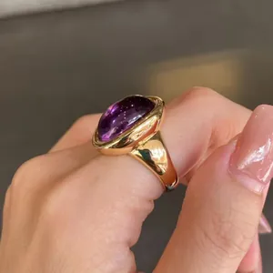 Close-up of a vintage 24K gold plated silver ring featuring a large oval amethyst stone