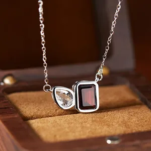 Detail view of S925 silver necklace with pear and emerald cut gemstones