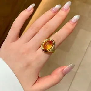 Close-up of a vintage oval citrine ring in 24K gold plated silver worn on a hand