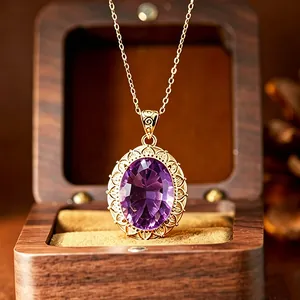 Detailed macro view of an elegant millennium cut oval amethyst pendant with gold filigree