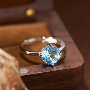 Detail view of 925 sterling silver ring featuring a faceted hexagonal blue topaz gem
