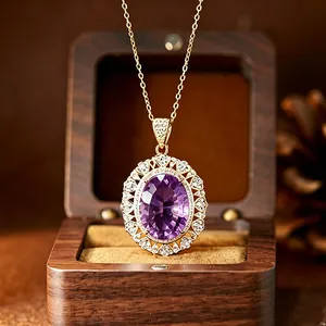 Close-up detail of natural millennium cut amethyst pendant in a wooden jewelry box