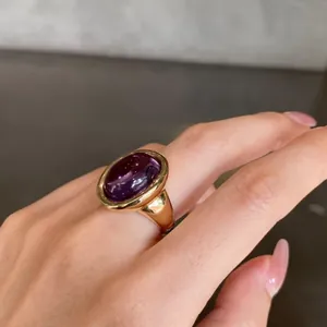 Close-up of a 24K gold plated sterling silver ring featuring a large purple amethyst.