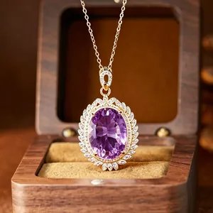 Close-up of luxury oval purple amethyst pendant necklace with sparkling stone halo