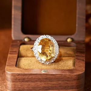 Detailed close-up of a large oval citrine ring set in a luxury wooden display box.