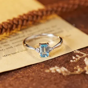 Detailed macro shot of a rectangular blue topaz gemstone set on a S925 silver ring band.