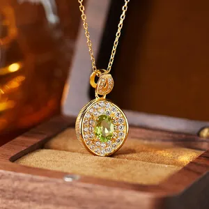 Detailed macro view of an elegant oval green gemstone pendant with micro-pavé stones