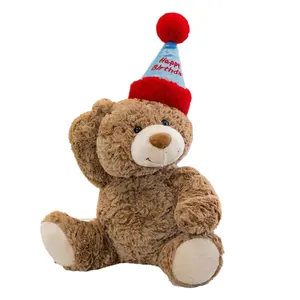 Adorable brown curly plush teddy bear wearing a blue Happy Birthday party hat accessory