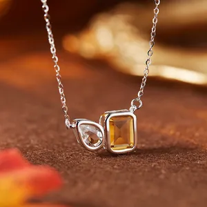 Detailed view of an S925 sterling silver necklace with rectangular citrine and white topaz stones.