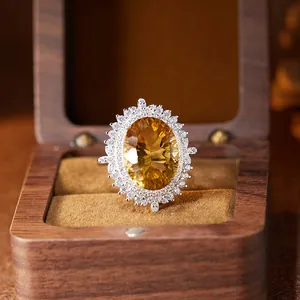 Luxury close-up of a large oval yellow citrine ring presented in a vintage wooden gift box