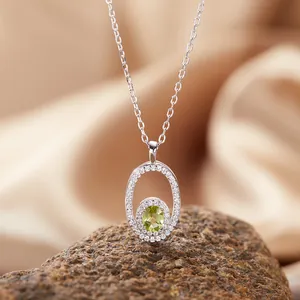 Detailed macro shot of an elegant oval peridot pendant necklace with S925 silver chain