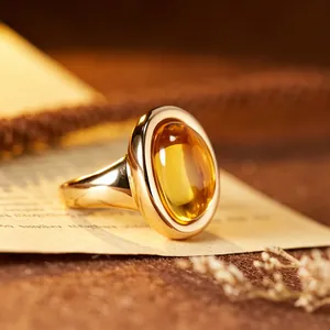 Close-up detail of a vintage 24K gold plated citrine ring with oval stone